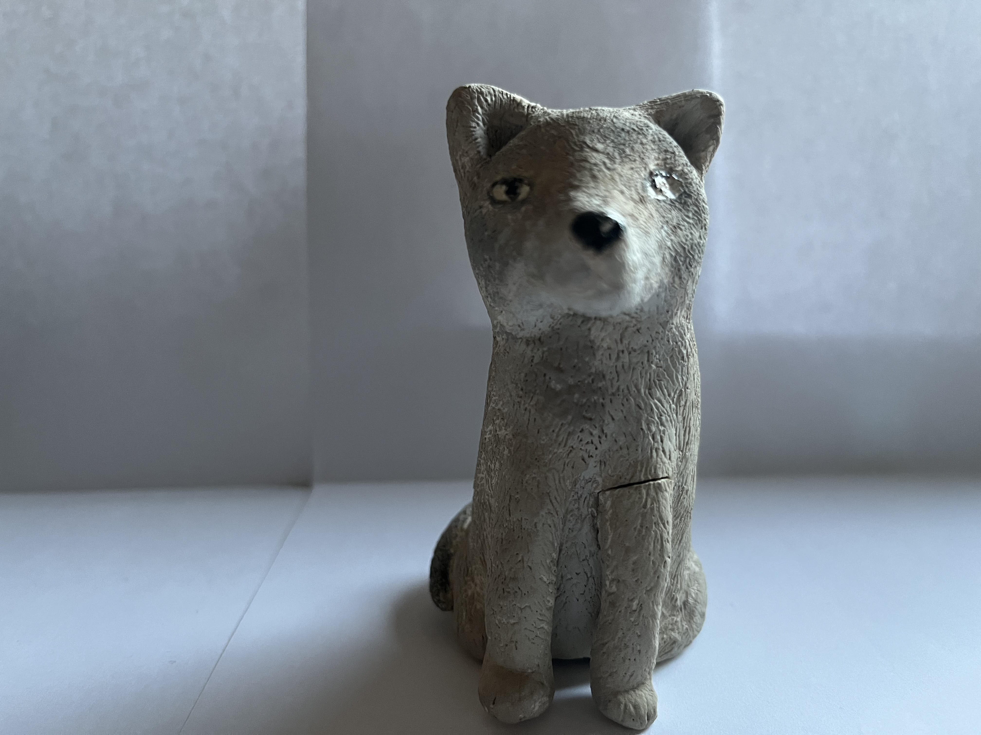 Sitting ceramic coyote statue