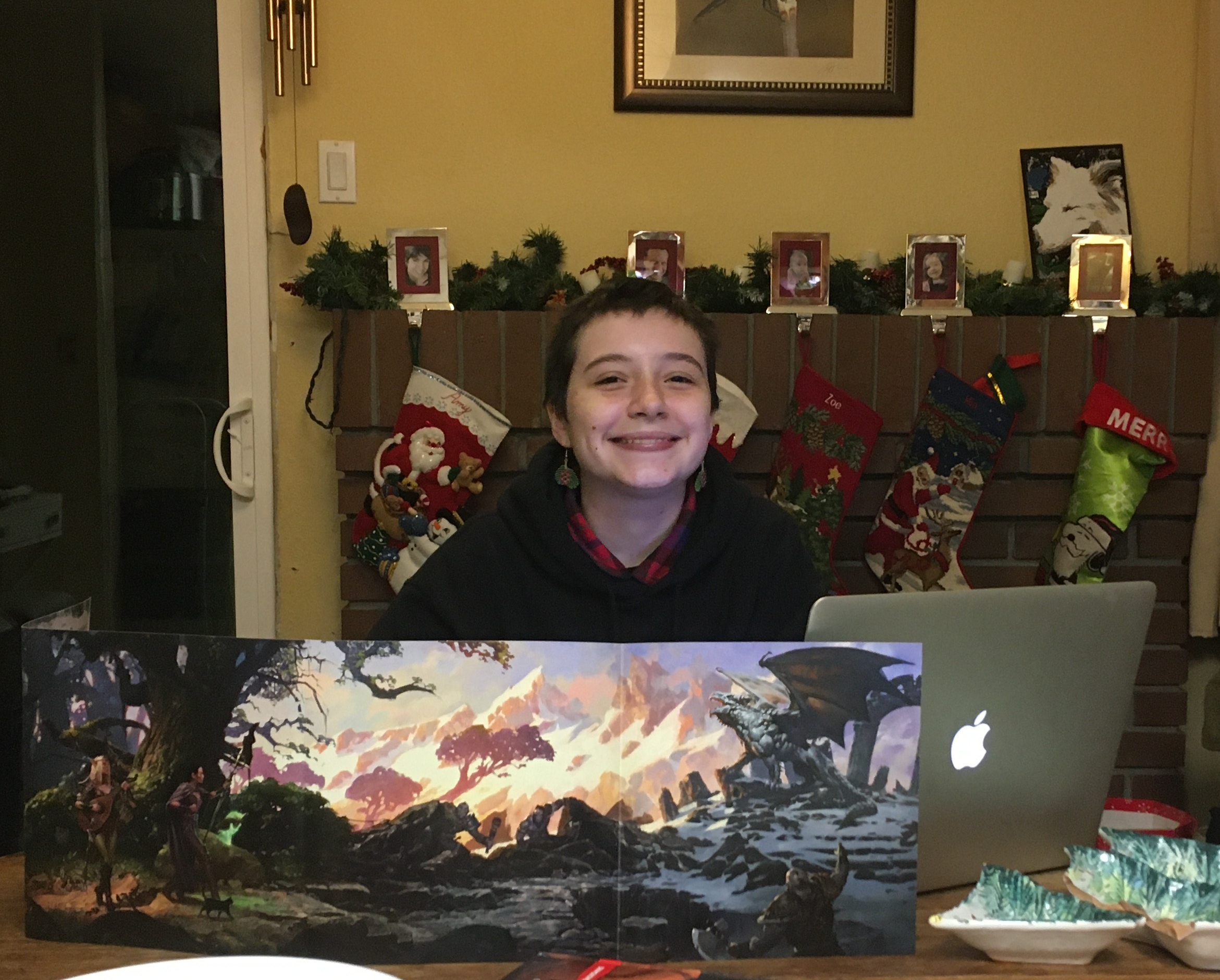 Mia smiles gleefully from behind a DM screen