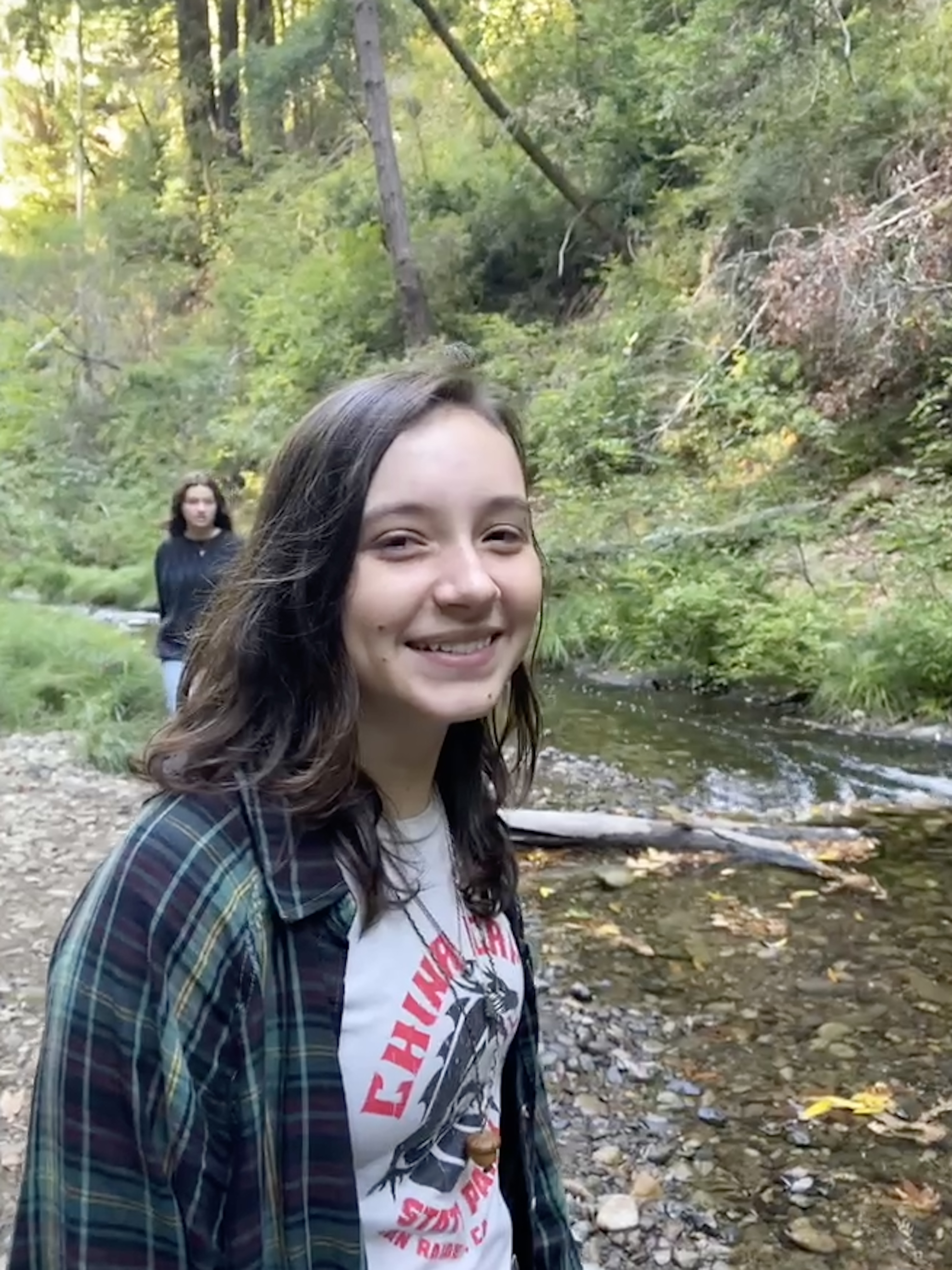 Mia standing in front of a creek