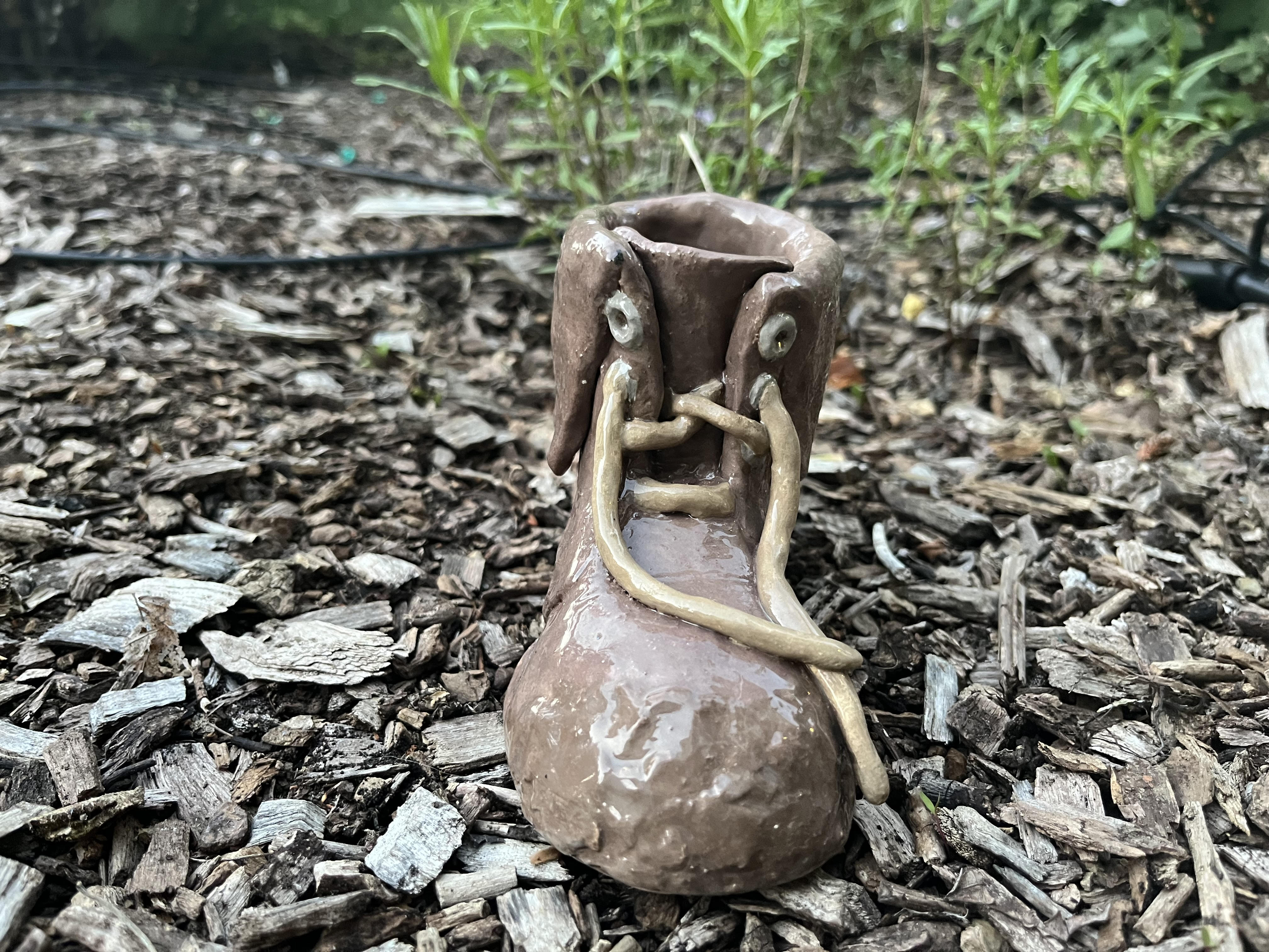 A ceramic unlaced, folded over, muddy boot