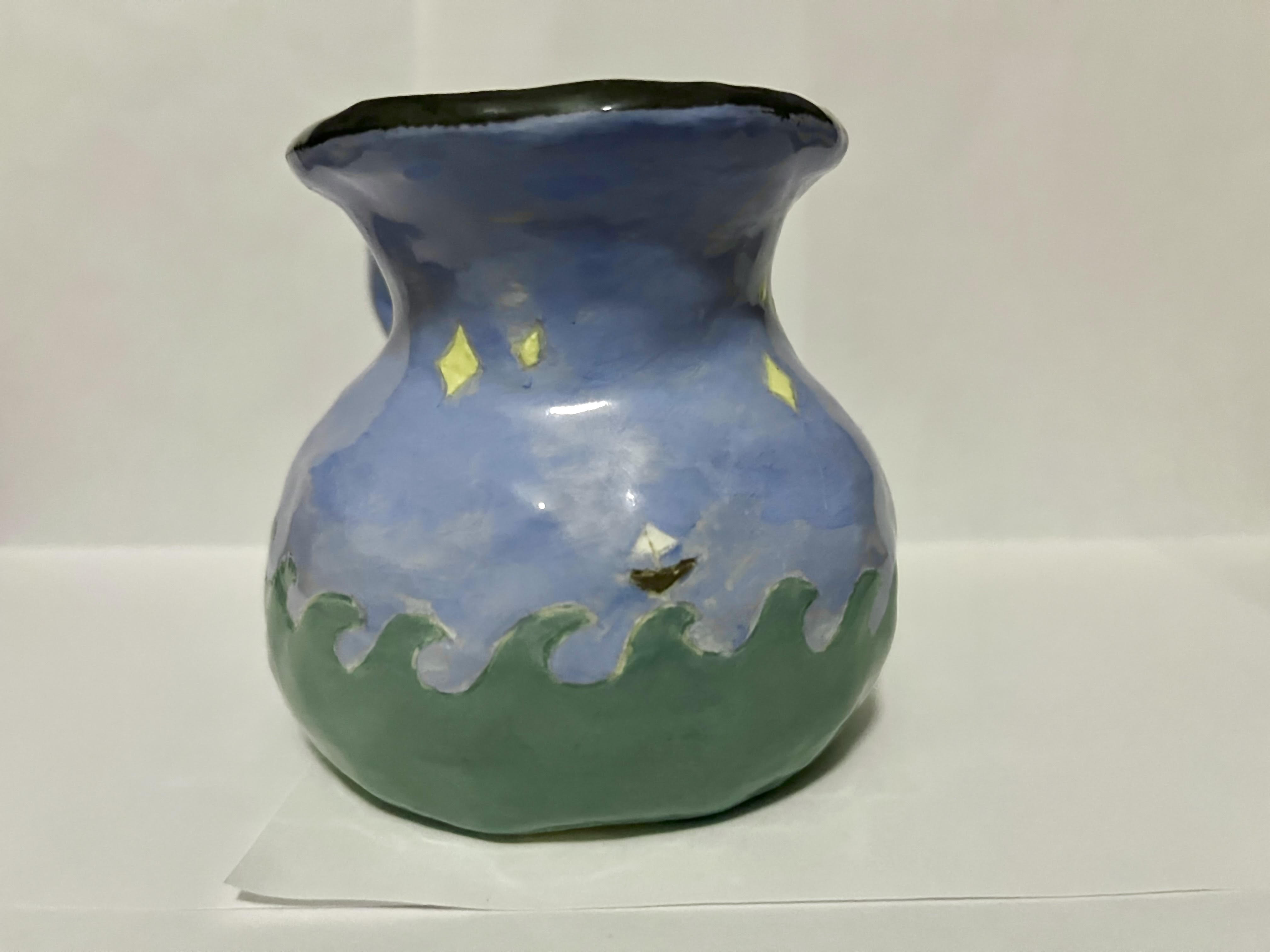 Pitcher shaped ceramic mug with waves and a boat